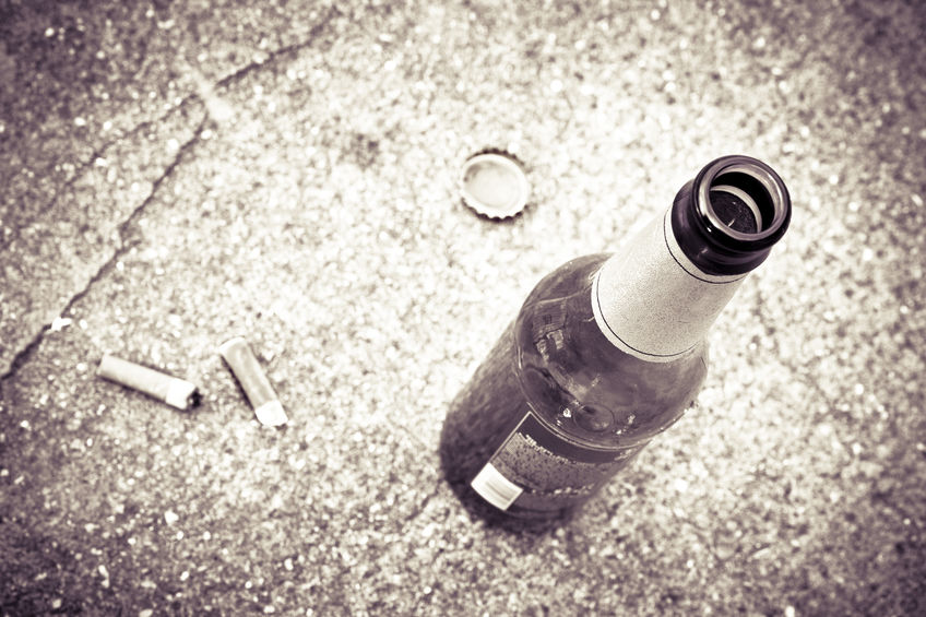 Bottle of beer resting on the ground