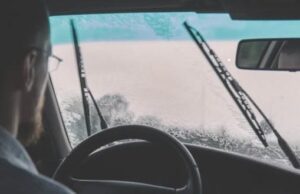 Person driving with windshield wipers on
