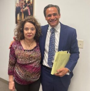 Attorney Mike Bottaro standing next to a client after her settlement