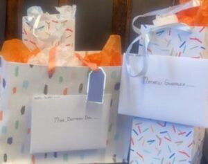 two gift bags with envelopes attached