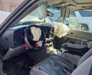 interior of SUV showing deployed airbags