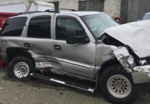 gray SUV with smashed rear passenger side and crunched front hood from car accident damages