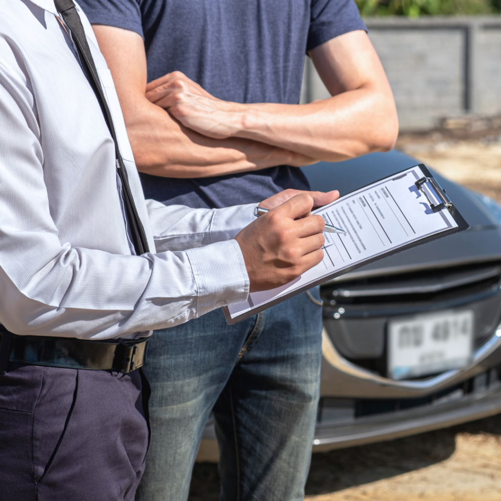 Individuals exchanging insurance and recording accident details for a Rhode Island personal injury claim Individuals exchanging insurance and recording accident details for a Rhode Island personal injury claim